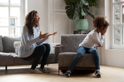 stubborn african kid ignoring mom scolding lecturing