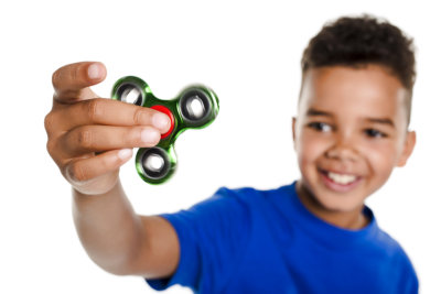 boy with fidget spinner held
